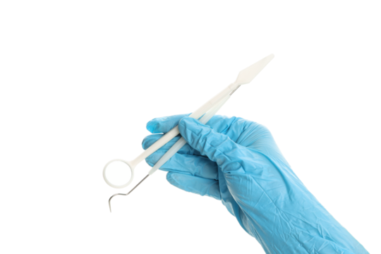 Gloved hand with dental tools for treatment, PNG