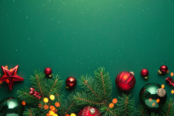 Christmas background with xmas tree, Christmas red ornament and sparkle bokeh lights on green...
