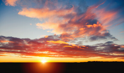 The sun sets below the horizon, filling the sky with shades of pink and orange at dusk creates a stunning canvas.
