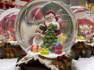Festive christmas snow globe featuring santa claus and gifts for holiday decoration