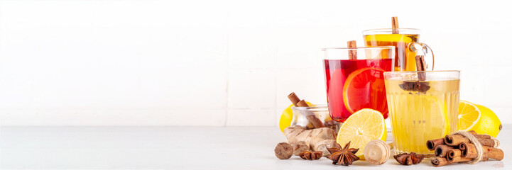 Three different Hot Toddy drinks in different tea cups - hot autumn winter tea cocktail beverages...