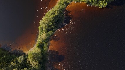 Aerial View of Two Lake Islands Connected by a Forested Land Bridge