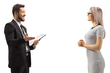 Man in a black suit talking to a woman in a casual dress