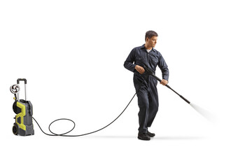 Worker cleaning with a high pressure washer machine