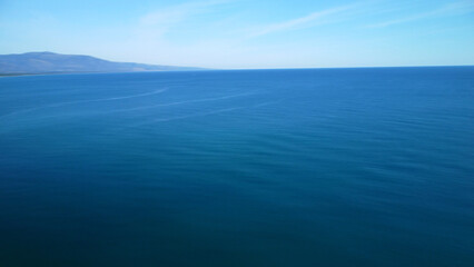 View of the Blue Ocean with a Distant Mountain Range on the Left