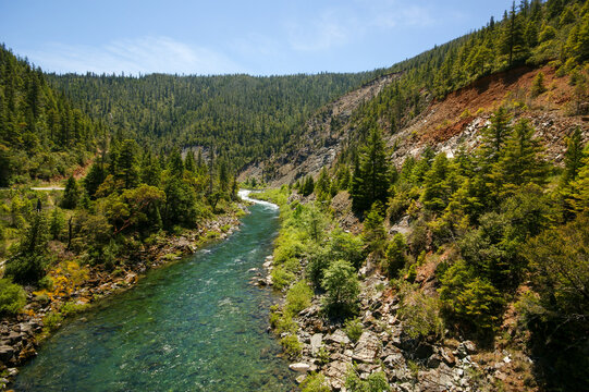 Smith River flowing through a mountain valley with conifer forest in Northern California
