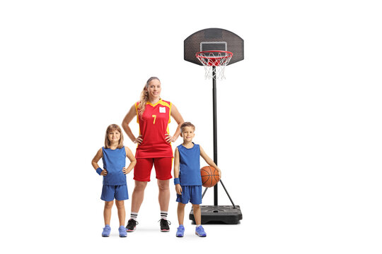 Female basketball coach posing with a group of kids