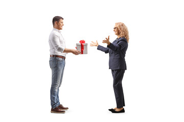 Full length profile shot of a man giving a present to a woman