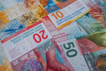 Swiss Franc banknotes in colorful layout symbolizing national currency, financial stability and...