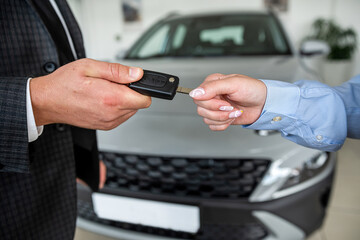 Handshake after success deal sale purchase between customer and dealer at showroom.