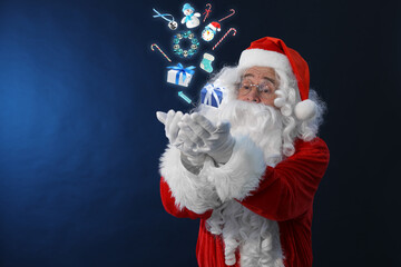 Santa Claus levitating Christmas decor and gift boxes on blue background. Festive magic