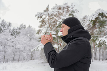 Man outdoors during winter scenery in cozy attire