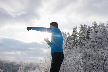 Man exercising outdoors during winter in snowy landscape