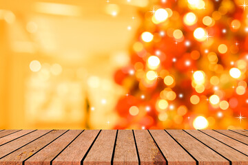 Wooden table with warm golden bokeh lights and sparkling Christmas decorations or Thanksgiving in...