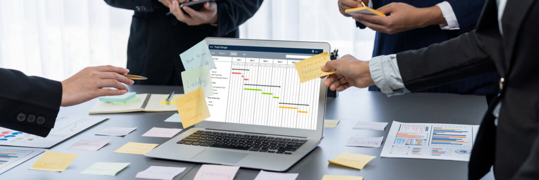 Project planning software for brisk business project management on the computer screen showing timeline chart of the team project
