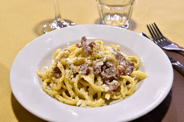 Tonnarelli alla gricia is a tipical egg pasta whit bacon and pepper made In Rome Lazio Italy