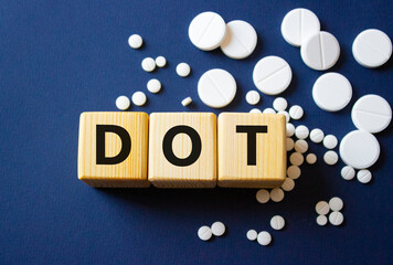 DOT symbol. Wooden cubes with words DOT Department of Transportation. Beautiful deep blue...