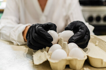 Chef in Black Gloves Handling White Eggs