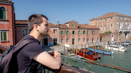 Man enjoying view from Ponte Longo in Venice