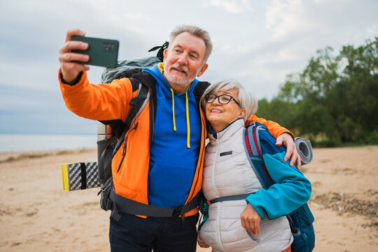 Hiking tourism adventure. Senior couple making selfie enjoying outdoor recreation hiking. Old people backpackers hikers taking photo enjoy walking hike trekking active vacation beauty of nature