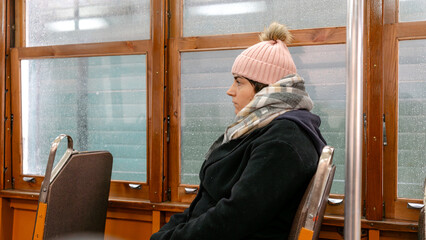 Woman riding a classic Lisbon tram