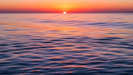 Fototapeta premium Deep Blue Ocean Waves Under a Fiery Sunset Sky with Sun Setting on Horizon Keywords: ocean, sea, water, waves, sunset, sky, horizon, red, orange, purple, blue, reflection, nature, seascape