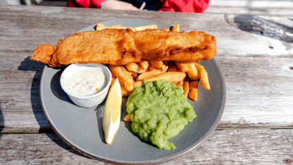Traditional fish and chips with mushy peas and tartar sauce