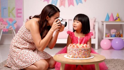 Mother capturing daughter's special birthday moment with camera