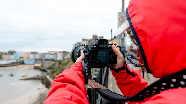 Photographer capturing scenic Tenby from a viewpoint