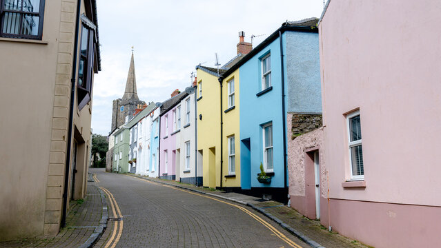 Vibrant coastal houses in Tenby under a cloudy sky