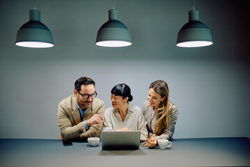 Business professionals discussing work and sharing ideas during a corporate meeting in a modern office environment