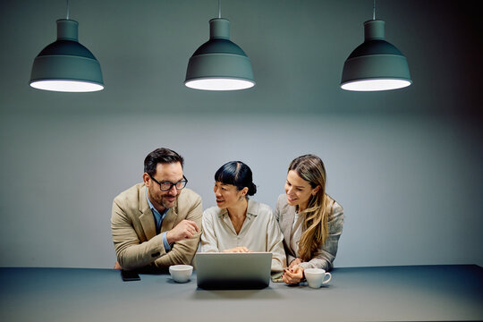 Business professionals discussing work and sharing ideas during a corporate meeting in a modern office environment