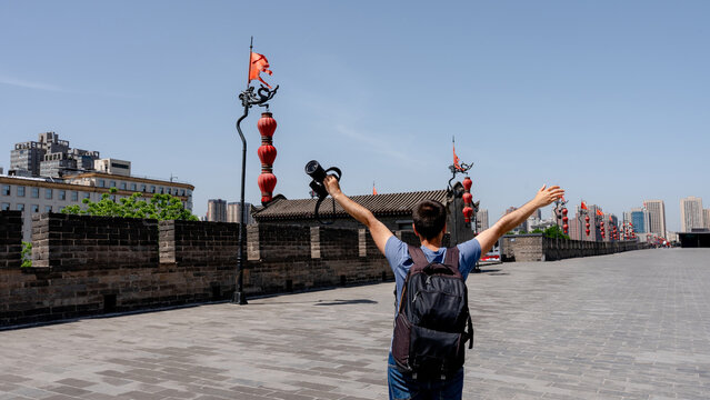 Man on the Great Wall of Xian with camera