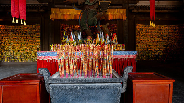 Incense burner with vibrant sticks at Cheng Huang Temple