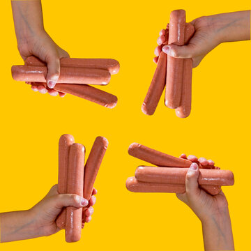 Hands holding hot dogs against a yellow background