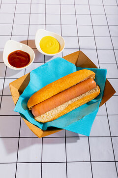 Delicious hot dog with mustard and ketchup on table