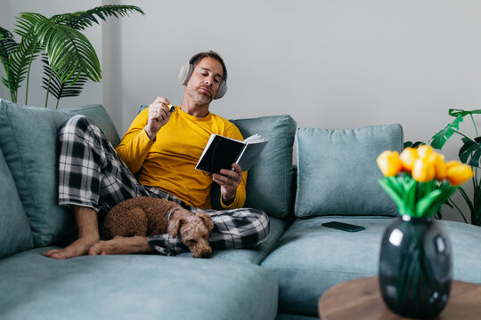 Man relaxing at home with notebook and headphones