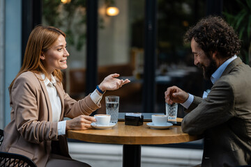 Business people discussing during coffee break at outdoor cafe