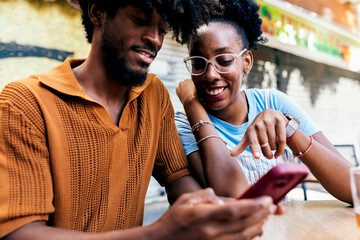 Happy couple sharing media on a smartphone together