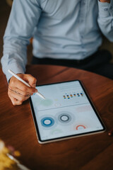 A hands-on view of a person in a light shirt working on a tablet, exploring charts and circular...