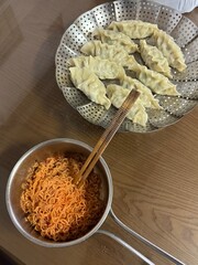 Korean Spicy Bibim Noodles with Steamed Dumplings on Table