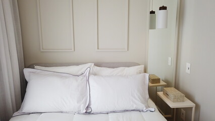 Elegant Bedroom with Cozy Bed, Light Decor, and Warm Sunlight