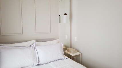 Elegant Bedroom with Cozy Bed, Light Decor, and Warm Sunlight