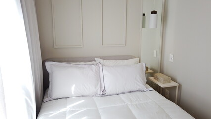 Elegant Bedroom with Cozy Bed, Light Decor, and Warm Sunlight