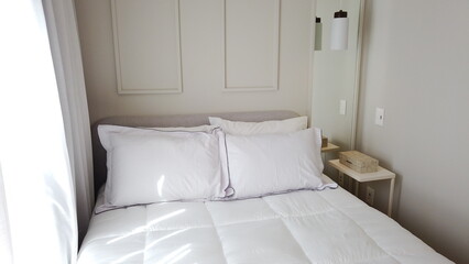 Elegant Bedroom with Cozy Bed, Light Decor, and Warm Sunlight 