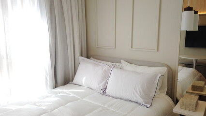 Elegant Bedroom with Cozy Bed, Light Decor, and Warm Sunlight 