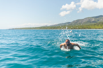 Swimming in the Mediterranean Sea with Scenic Backdrop