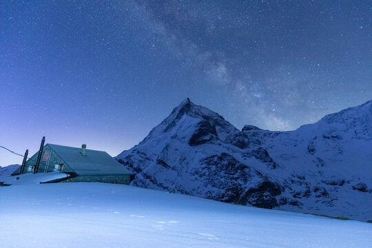 Mountain hut under starry sky near Zermatt's peaks