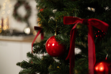 Christmas tree with red bauble and ribbon decorations
