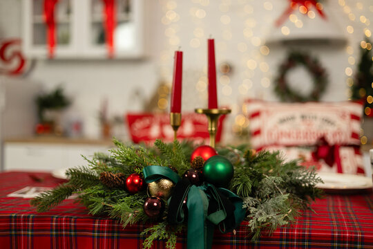Christmas table decor with candles and festive greenery